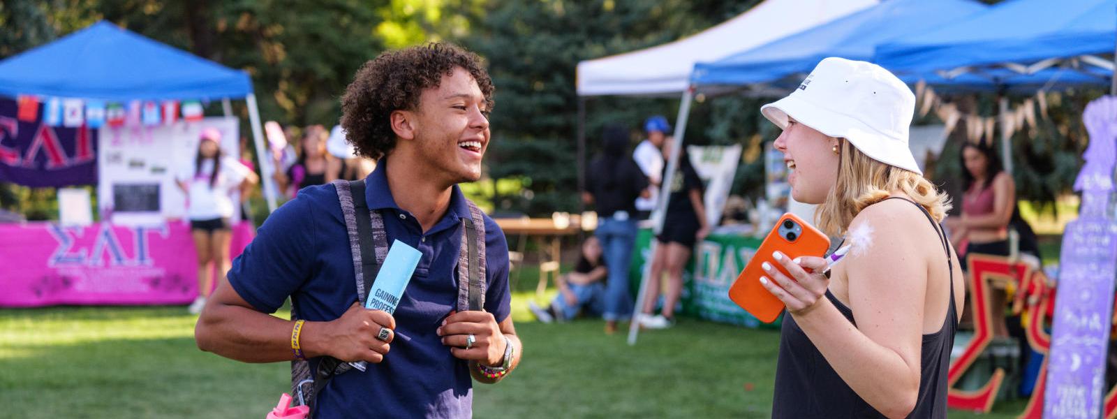 Students talking at a festival on campus.