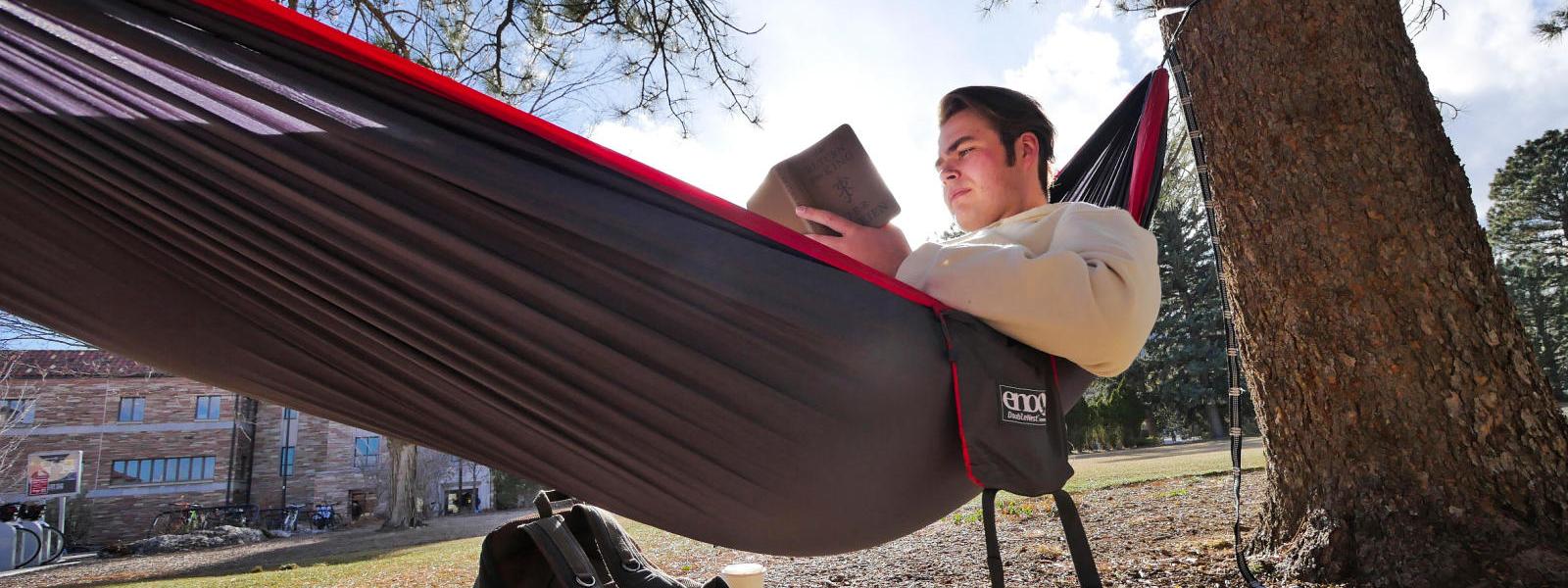 Student studying in a hammock.
