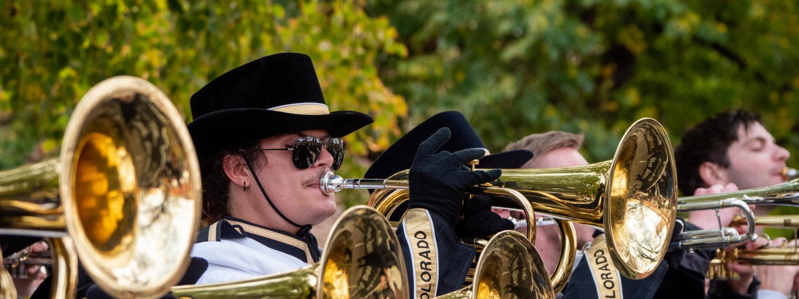 marching band members playing mellophones