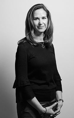 Jennifer Bixler, in black and white, against a gray background.