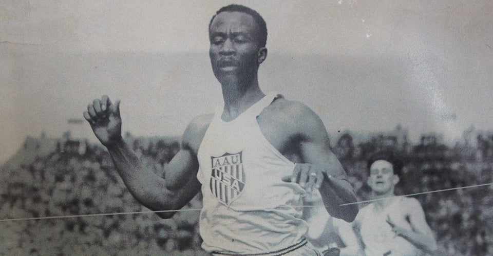 A black-and-white photo of David Bolen running on a track.