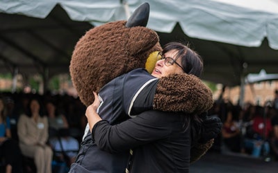 Laura Kornish gets a hug from Chip, the Buffaloes mascot. 