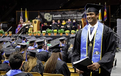 Atul Raguveer walks down the aisle, surrounded by his seated classmates.