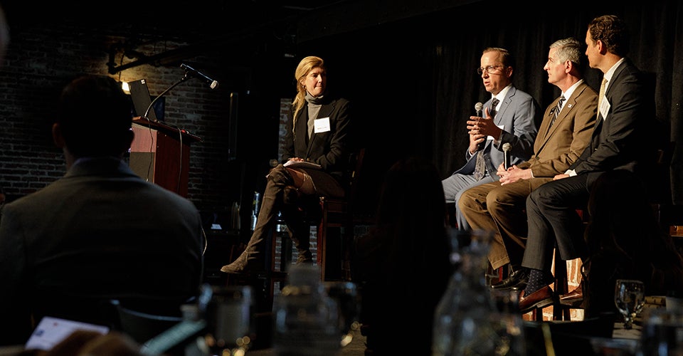 A group of four professionals onstage.