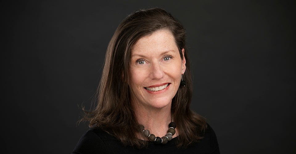 Portrait of Sheila Duffy against a dark background