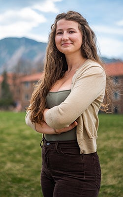 Emma poses on the business quad in professional attire.