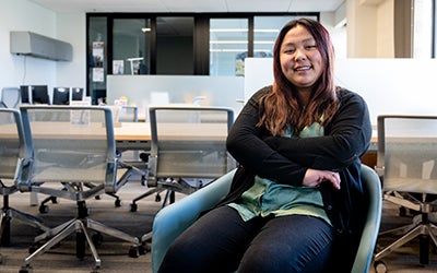 Christina in a chair in the Deming Center's new offices.