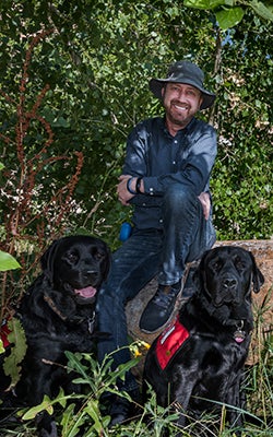 Erick outside the Koelbel Building with his two English retrievers.