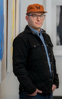 Tim Weiss posing in the corridor of his office.