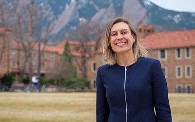 Kathryn Wendell in business attire standing on the CU Boulder main campus. 