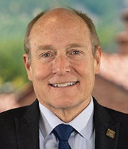 Professional headshot of Mike Kercheval in a blue suit and tie.