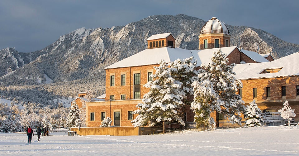 The Koelbel Building after a snowstorm, with the Flatirons in the background.