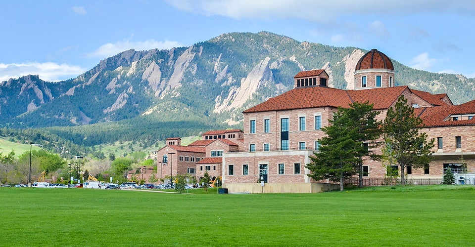 The KJoelbel Building on the CU Boulder campus, with the Flatirons in the background.