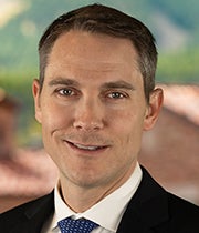 Headshot of Brian Lewandowski in a dark suit.