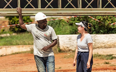 Maggie Grout speaks with a construction worker at a project site.