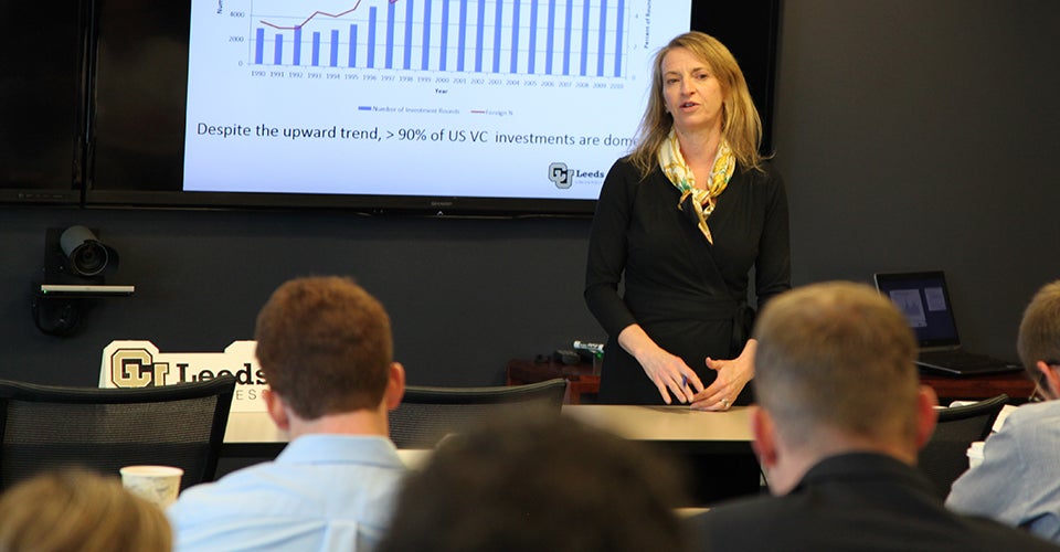 Sharon Matusik stands in front of a projected slide as she walks a class through a lecture.