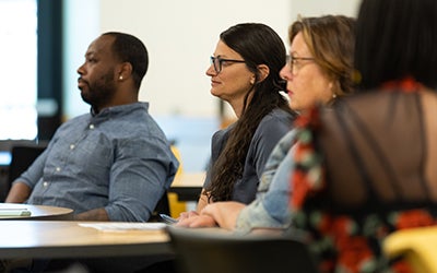 A panel of judges listens as a student presents. 