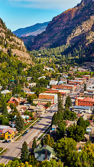 Aerial photo of an Ouray, Colorado, street with mountains looming.