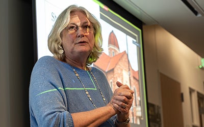 Cheryl Lindstrom addresses the audience of students and faculty.