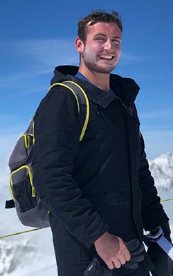 Steve Pardo stands outside in a snowy mountain scene.