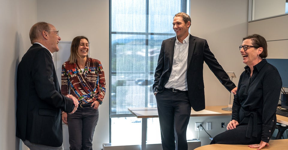 Center directors standing and talking in an office.
