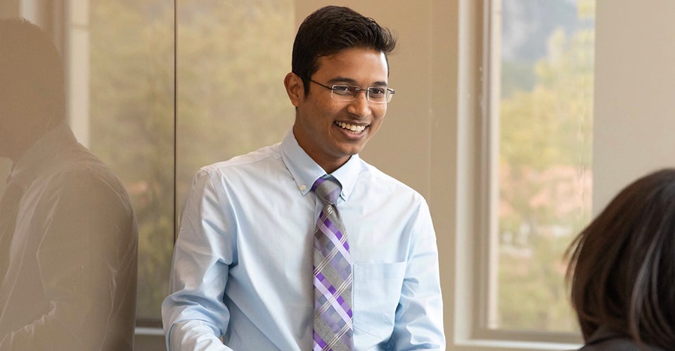 Sandip, in professional attire, leads a casual class discussion.