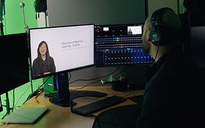 A man works with video editing software in the studio.