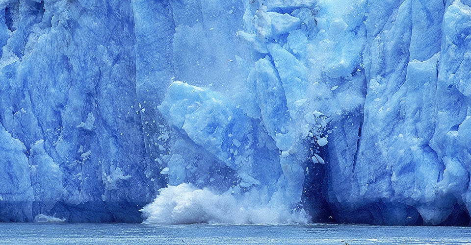 An iceberg melting into the ocean.