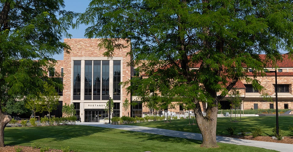 Exterior of the Koelbel and Rustandy buildings on the CU Boulder campus on a summer afternoon.