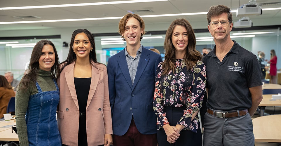 Five people standing in a lab.