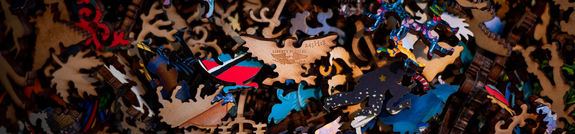 A group of mixed puzzle pieces. A signature Liberty whimsy piece, the eagle, is at the center.