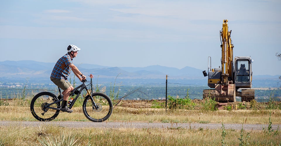 Jeff York riding his bike through the area devastated by the Marshall Fire. 