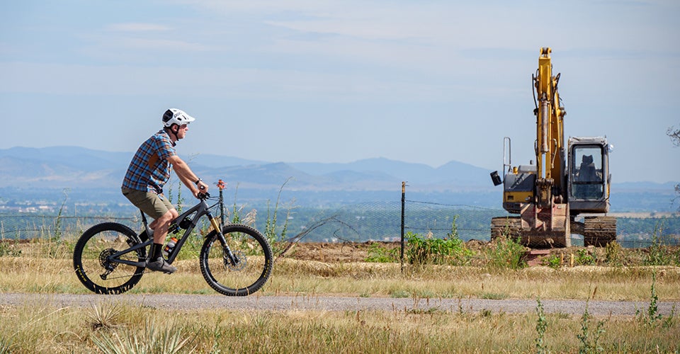 Jeff York rides his bike through the area devastated by the Marshall Fire. 