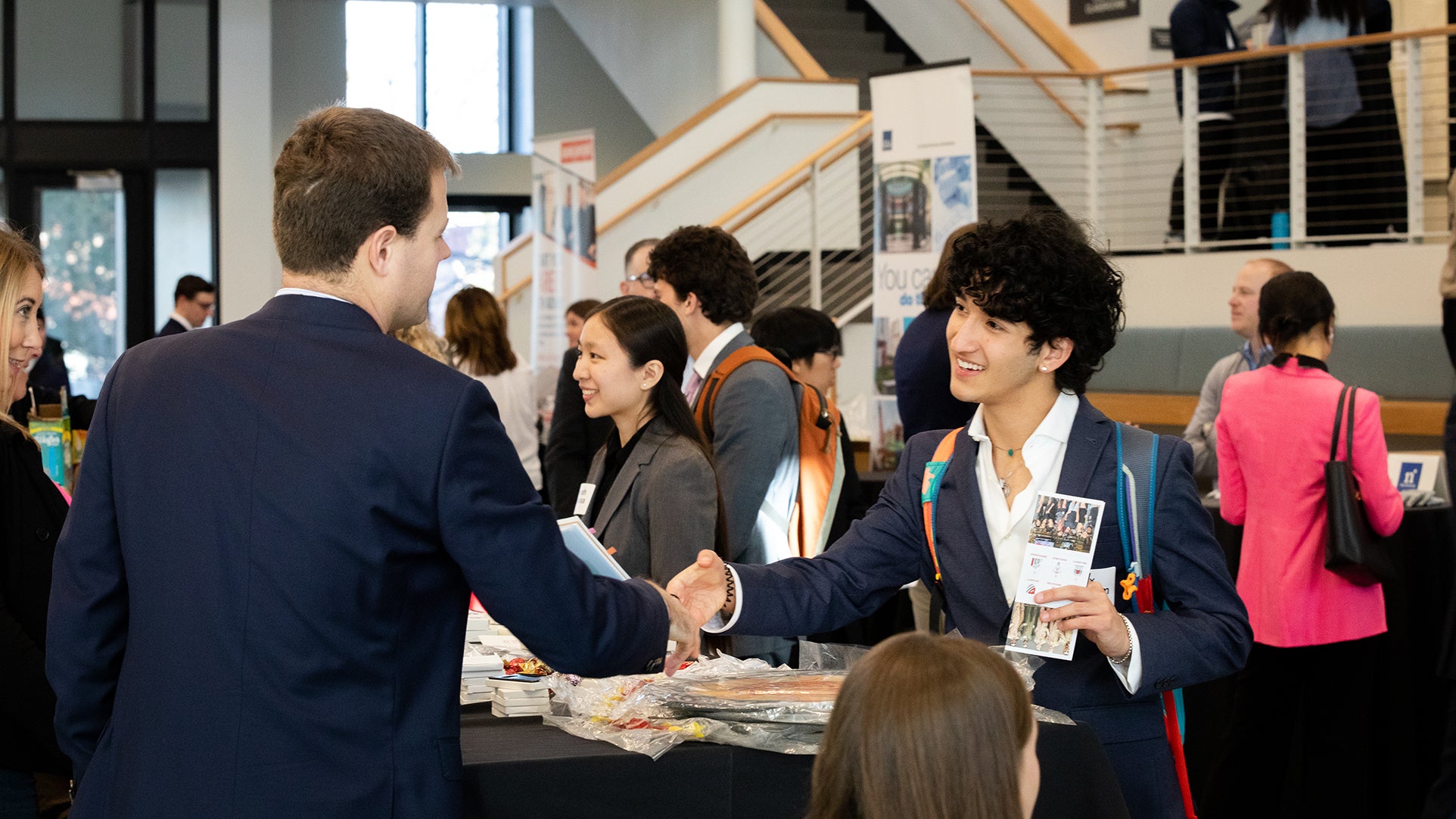 Students and employers networking in the Rustandy Building.