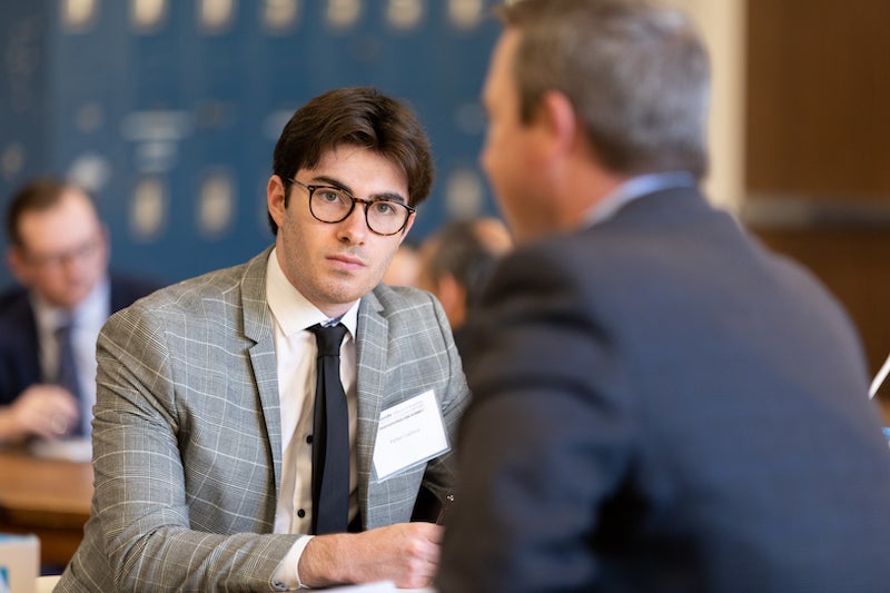 Leeds School of Business student networking with employers at a career fair