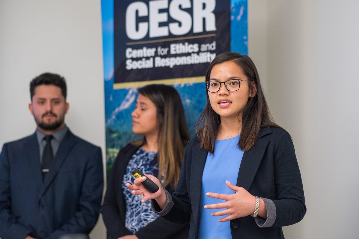 Woman speaking at a Center’s of Excellence case competition even