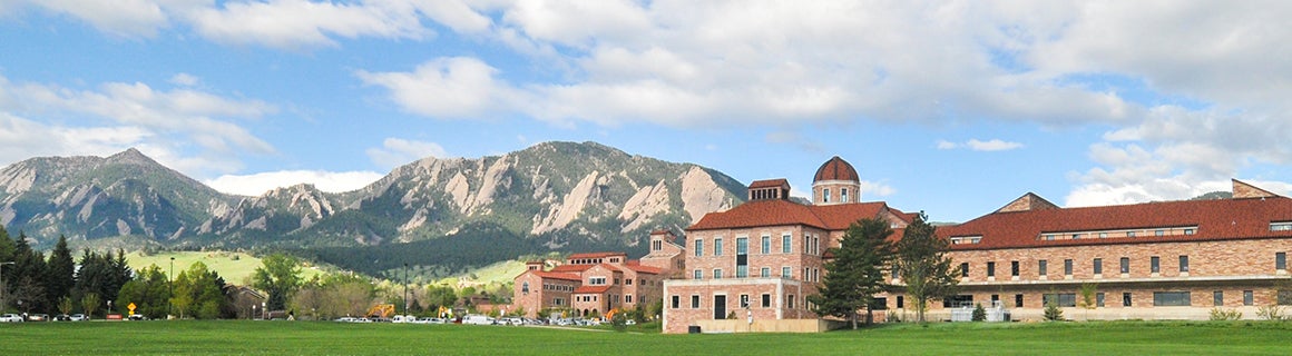 Image of the Koelbel building with the Flatirons in the background