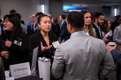 Image of students networking at the Leeds School of Business Career Fair