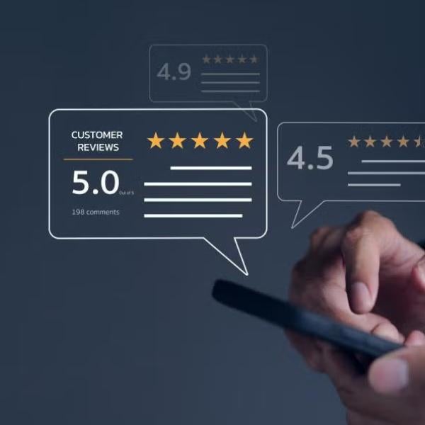 Hand holding phone with reviews above it