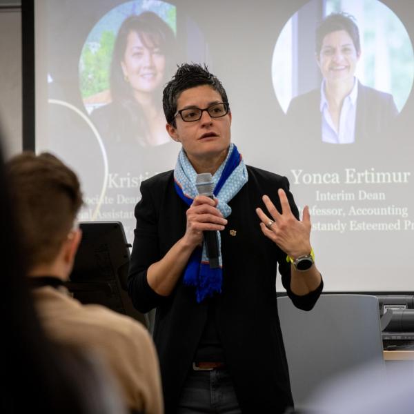 Yonca Ertimur speaks into a microphone