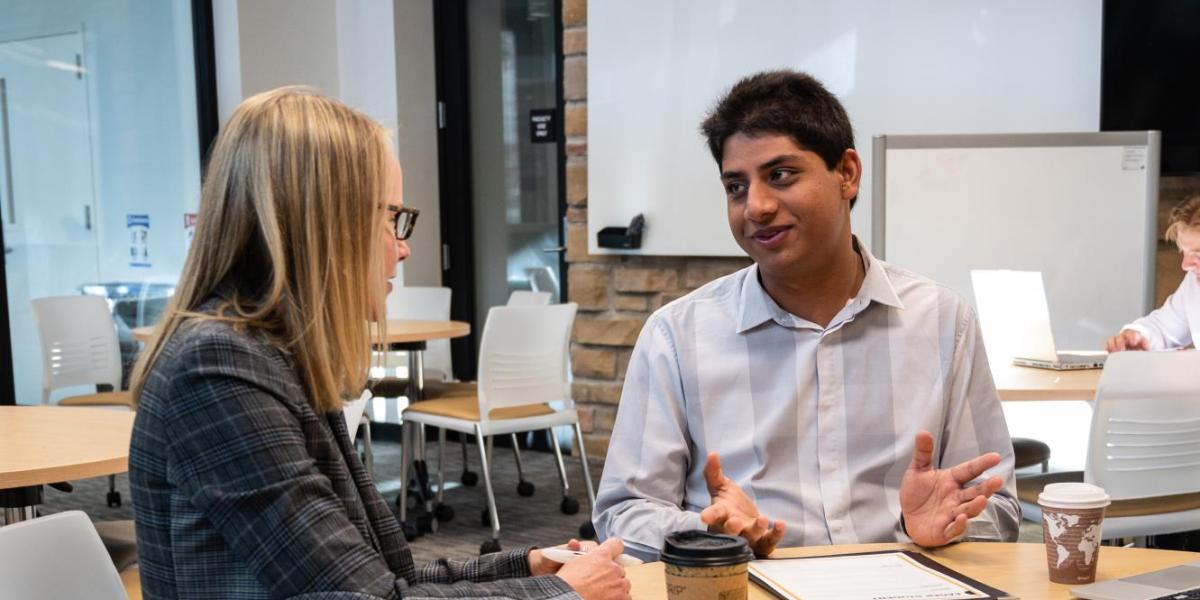 mentor and mentee sitting at a table together