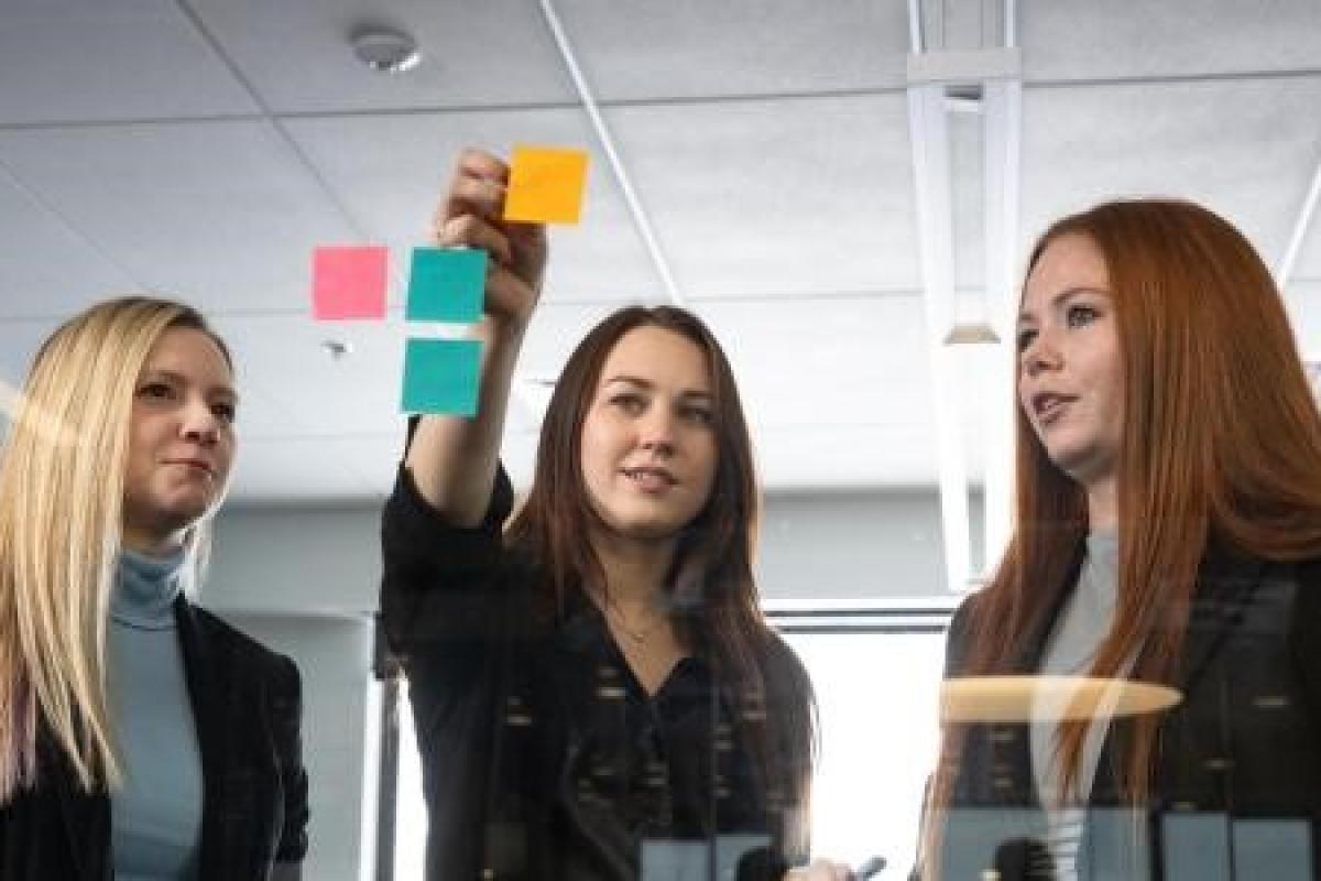 Group of students deciding on topics using post-it notes