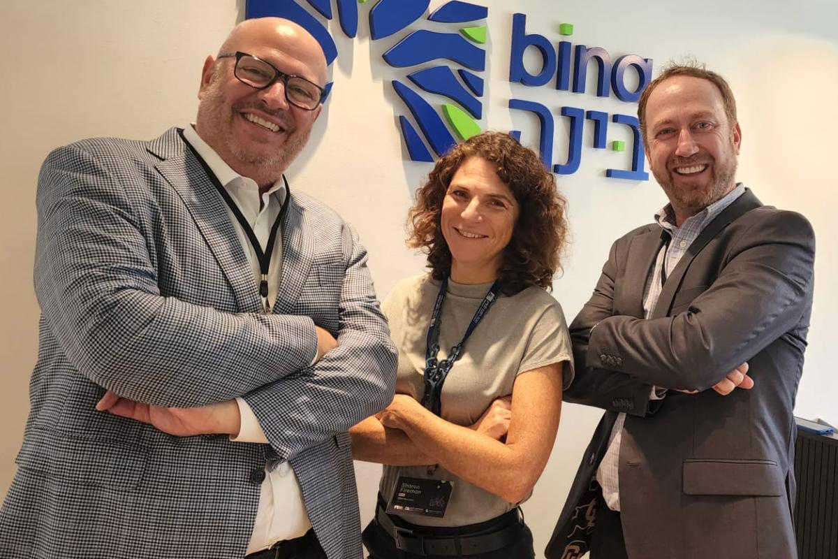 Three professionals pose for the camera.