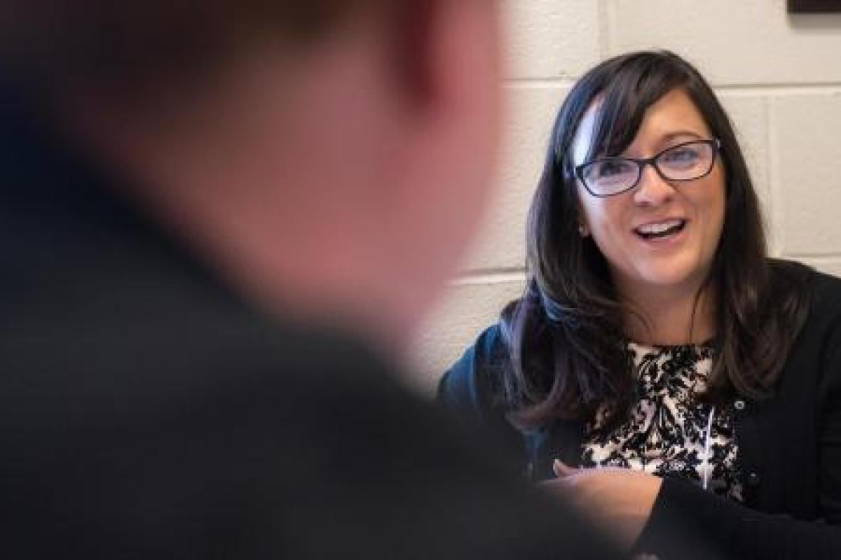 Student and Business Minor advisor at table