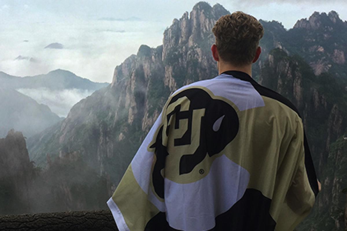 Education abroad student holding a CU flag