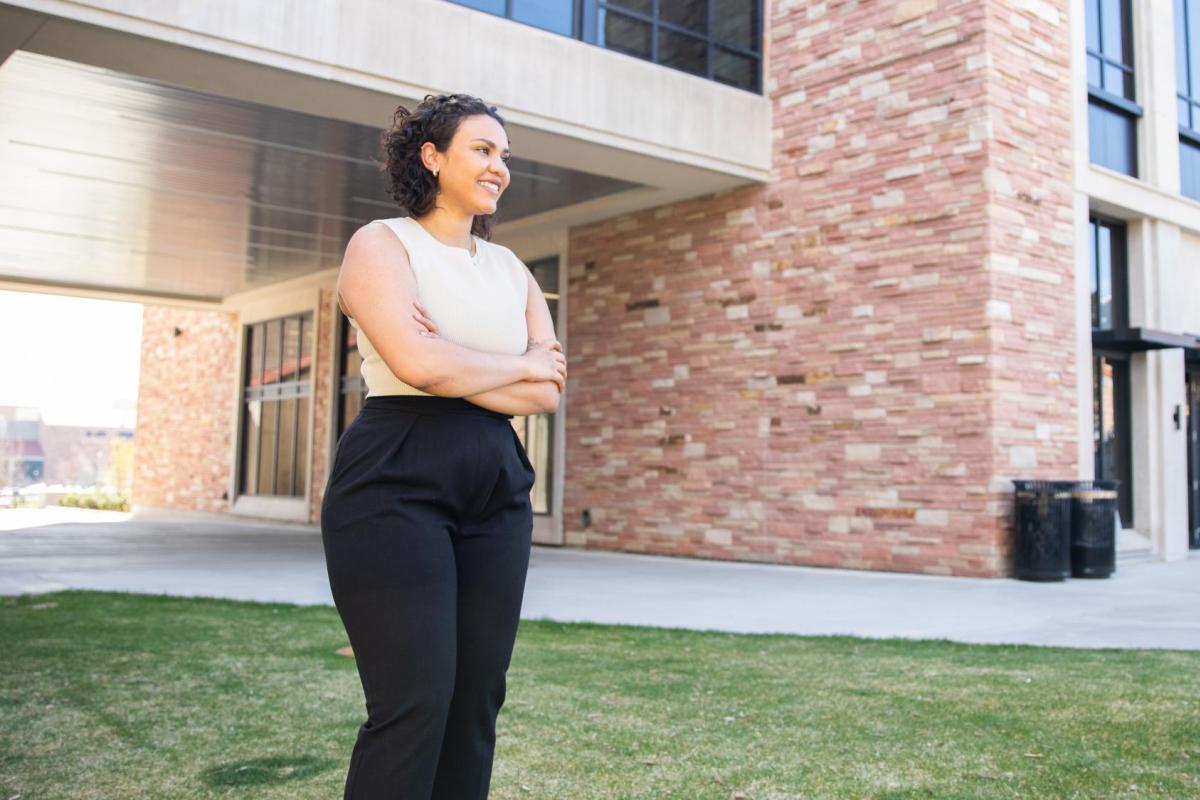 Jordyn looks confidently into the distance as she stands in front of the Rustandy Building.