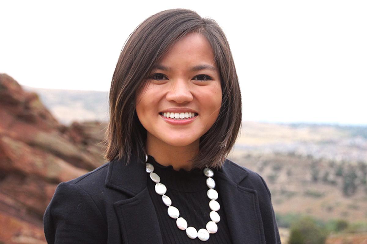 Headshot of Hayley Porter in professional dress at a park.