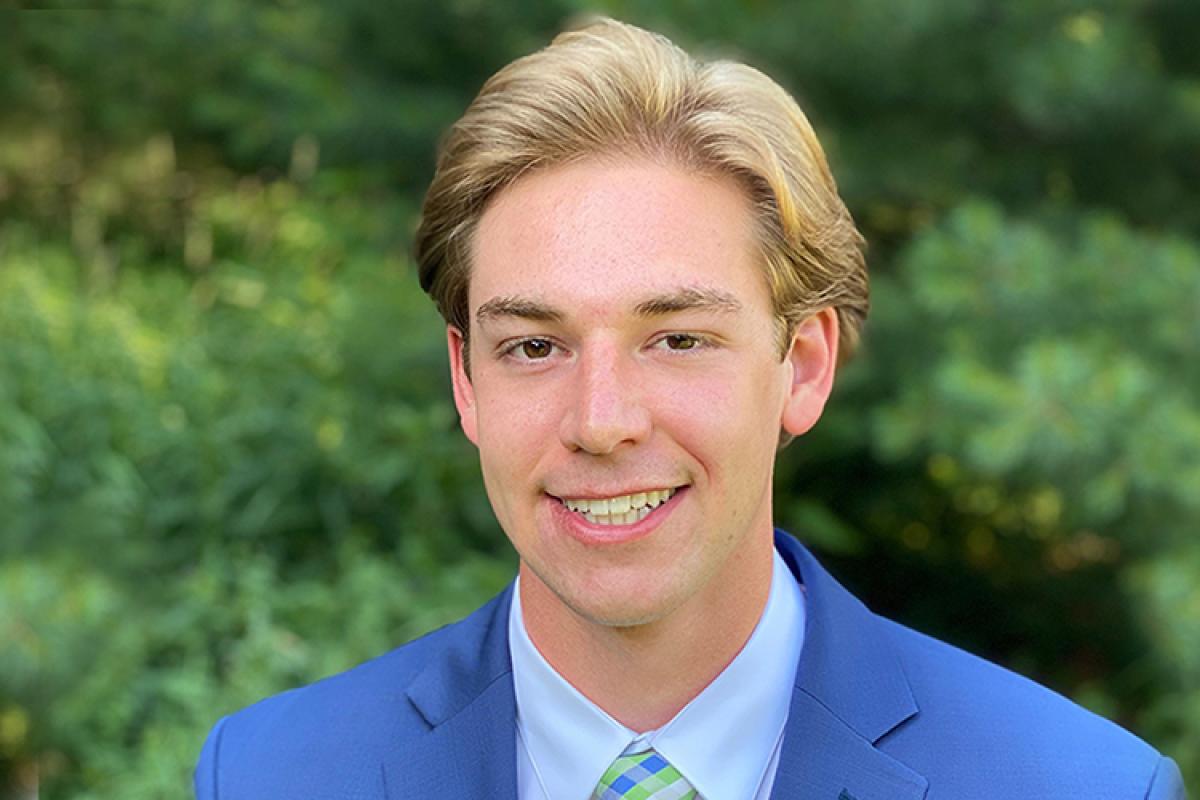 Headshot of Matt in a blue suit.