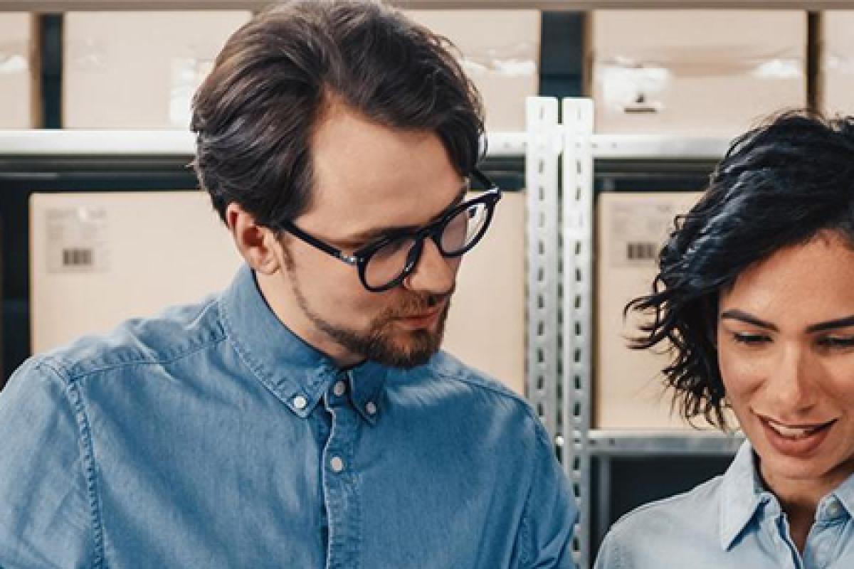 MS Supply Chain graduates conversing in a warehouse