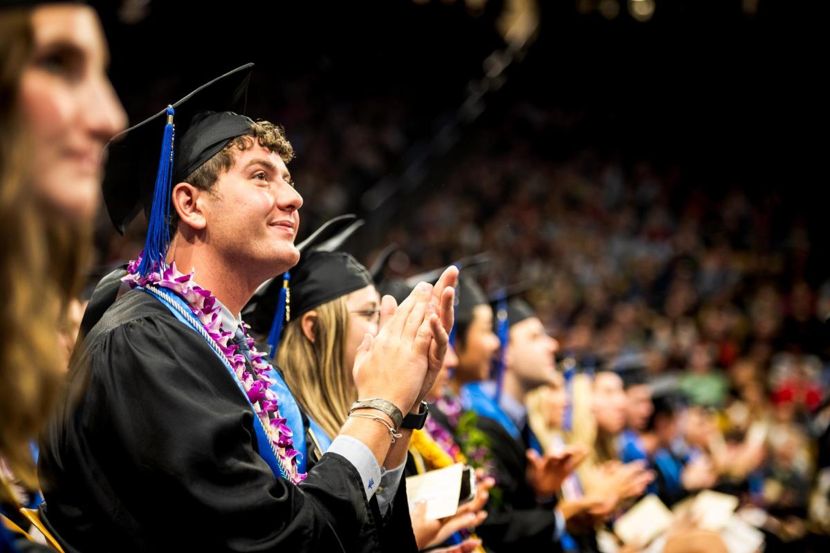 Students clapping in regalia during the Leeds Undergraduate Graduation Ceremony